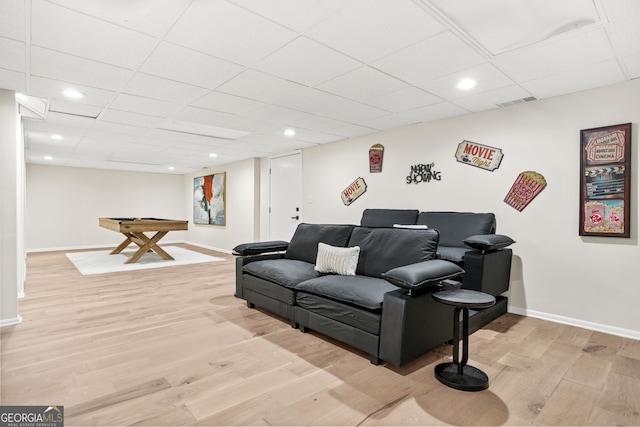 living room featuring light wood-style flooring, baseboards, recessed lighting, a drop ceiling, and billiards table