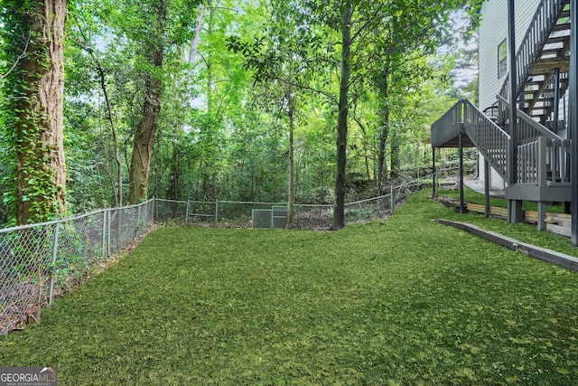 view of yard with stairway and a deck