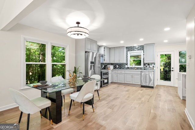 dining area featuring light wood-style floors, recessed lighting, and baseboards