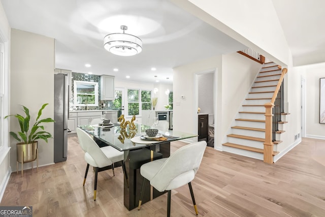 dining area featuring stairs, light wood finished floors, recessed lighting, and baseboards