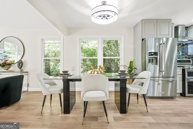 dining area with light wood-style flooring, baseboards, and a chandelier