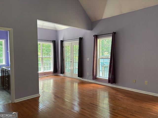 2828 Hicks Rd SW, Marietta, GA 30060 - spare room featuring lofted ceiling, hardwood / wood-style floors, and baseboards