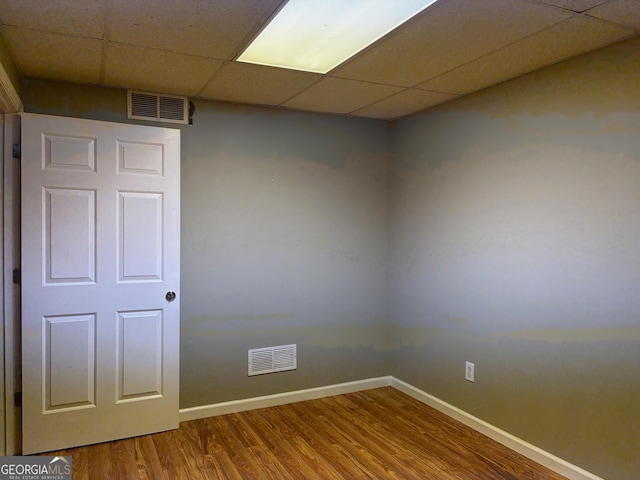 2828 Hicks Rd SW, Marietta, GA 30060 - empty room featuring a drop ceiling, wood finished floors, and baseboards