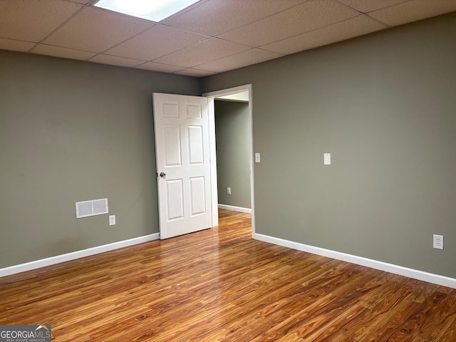 2828 Hicks Rd SW, Marietta, GA 30060 - spare room featuring wood finished floors, a paneled ceiling, and baseboards