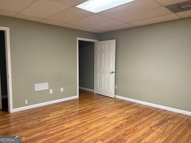 2828 Hicks Rd SW, Marietta, GA 30060 - spare room with wood finished floors, a drop ceiling, and baseboards