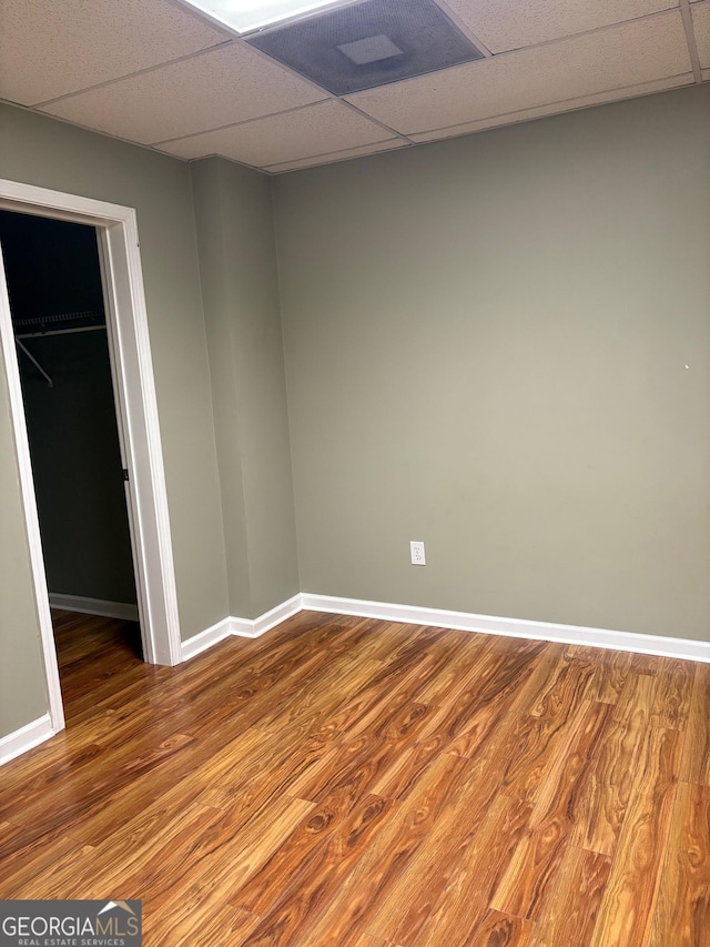 2828 Hicks Rd SW, Marietta, GA 30060 - unfurnished bedroom featuring a paneled ceiling, wood finished floors, a spacious closet, baseboards, and a closet