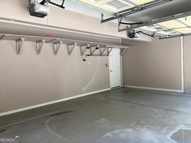 2828 Hicks Rd SW, Marietta, GA 30060 - garage with a garage door opener and baseboards