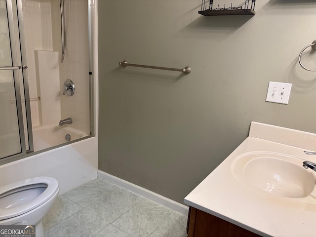 2828 Hicks Rd SW, Marietta, GA 30060 - bathroom featuring toilet, vanity, bath / shower combo with glass door, and baseboards