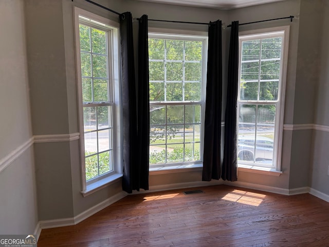 2828 Hicks Rd SW, Marietta, GA 30060 - unfurnished room featuring wood-type flooring, baseboards, and plenty of natural light