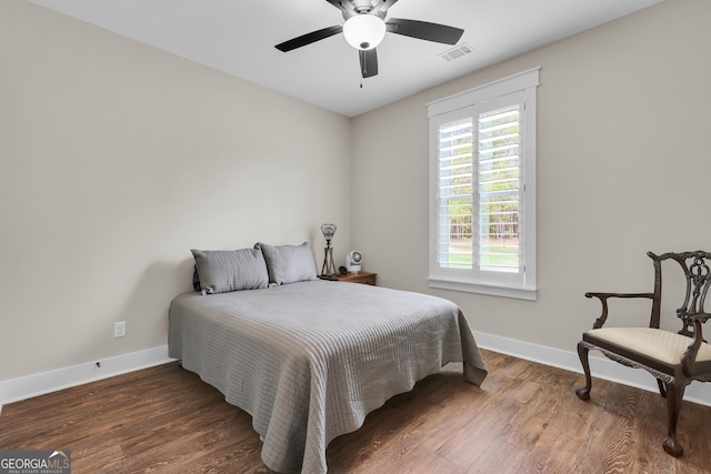 bedroom with baseboards, wood finished floors, and ceiling fan