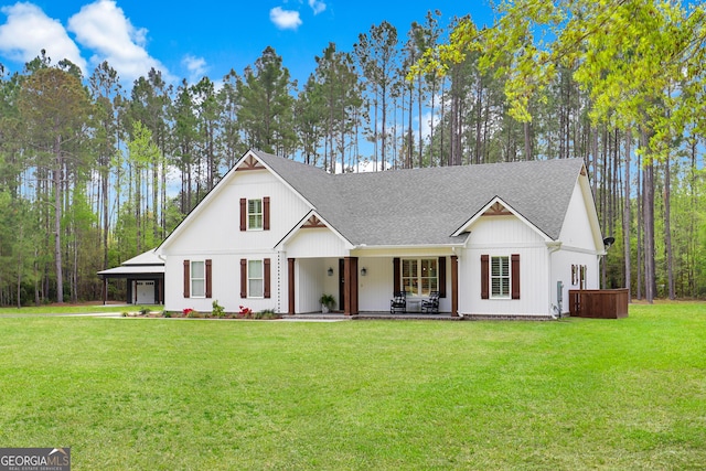 modern farmhouse with roof with shingles, a front lawn, and a carport