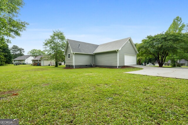 view of side of home featuring crawl space, a lawn, and driveway
