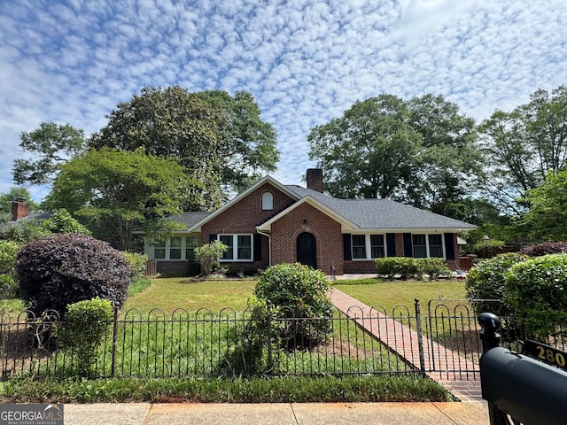 ranch-style home with a chimney and brick siding