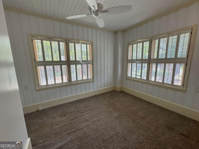 spare room with carpet, a ceiling fan, crown molding, and baseboards