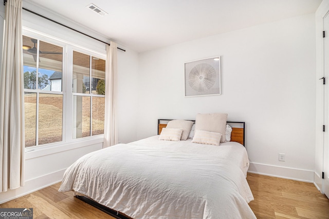 bedroom featuring wood finished floors and baseboards