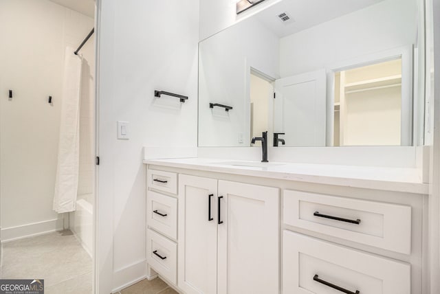 full bathroom featuring vanity, baseboards, shower / bath combination with curtain, and tile patterned flooring