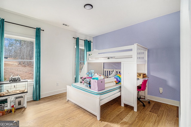 bedroom featuring wood finished floors and baseboards