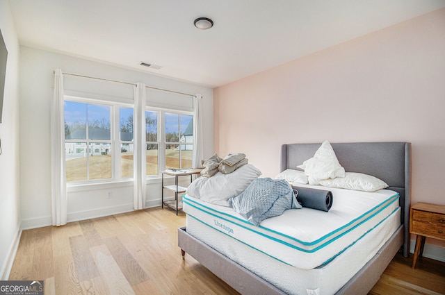 bedroom featuring wood finished floors and baseboards