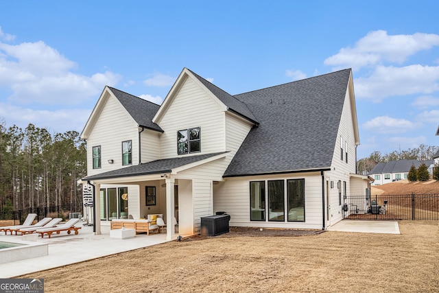back of property with an outdoor hangout area, a patio, roof with shingles, and fence