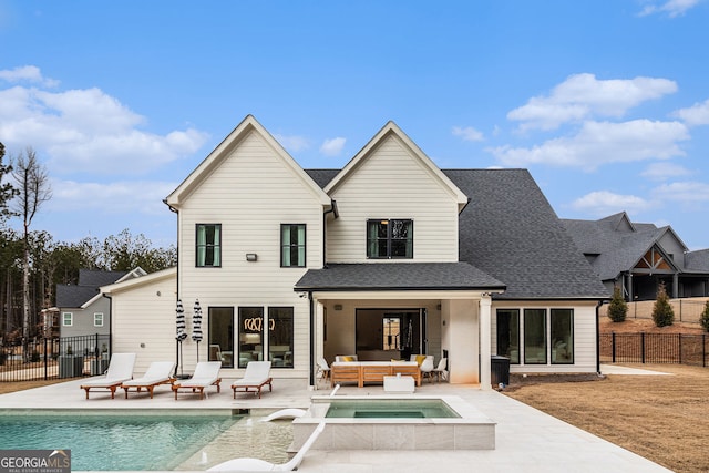 rear view of property featuring an outdoor hangout area, a patio, fence, and roof with shingles