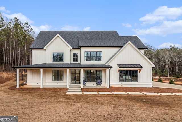 back of property with roof with shingles, a porch, and board and batten siding