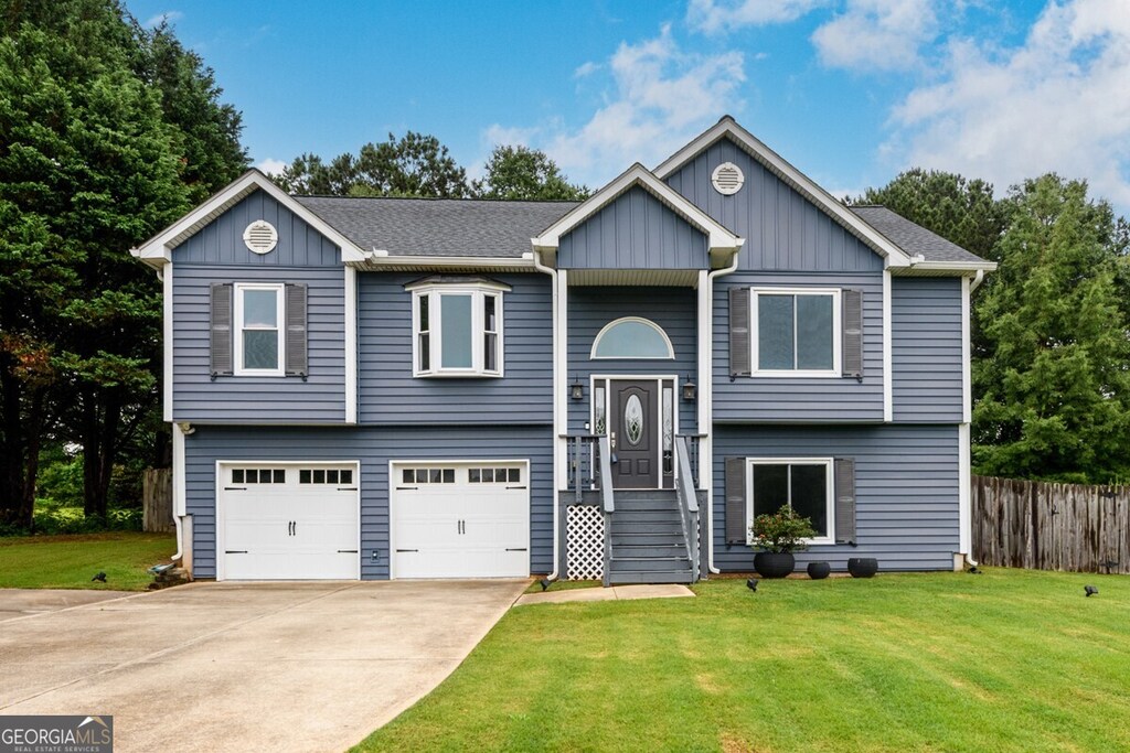 172 Cole Cir, Bethlehem, GA 30620 - split foyer home with a garage, concrete driveway, and board and batten siding