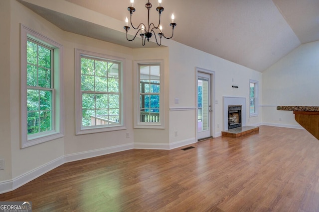 349 Bowen Hill Rd, Haddock, GA 31033 - unfurnished living room featuring wood finished floors, a chandelier, healthy amount of natural light, lofted ceiling, and baseboards