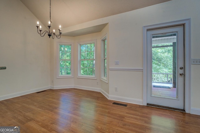 349 Bowen Hill Rd, Haddock, GA 31033 - unfurnished dining area featuring a chandelier, wood finished floors, vaulted ceiling, and baseboards