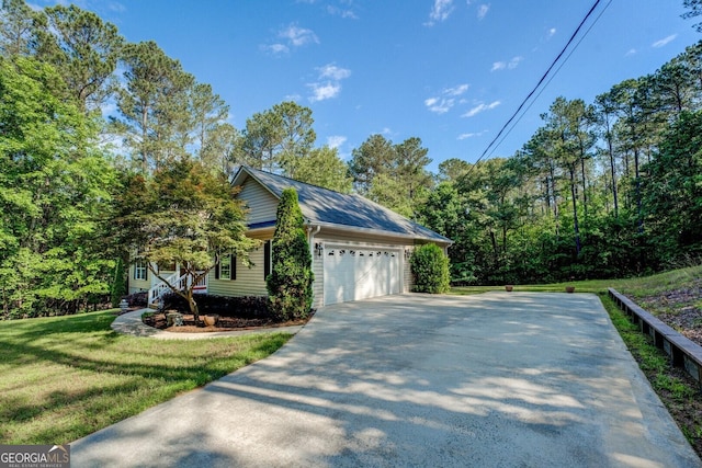 349 Bowen Hill Rd, Haddock, GA 31033 - view of home's exterior featuring a garage, a lawn, and concrete driveway