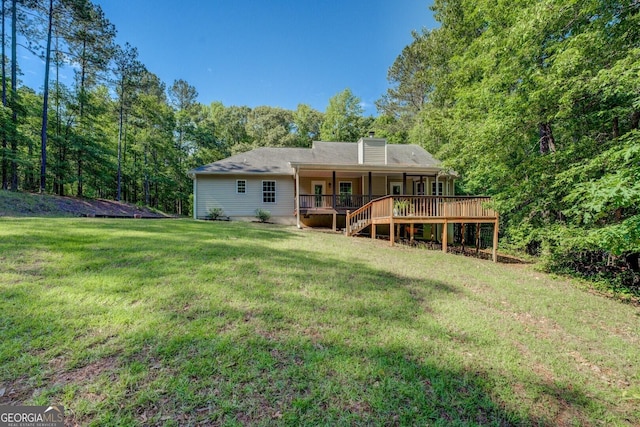 349 Bowen Hill Rd, Haddock, GA 31033 - rear view of house with a yard, a chimney, a wooden deck, and a view of trees