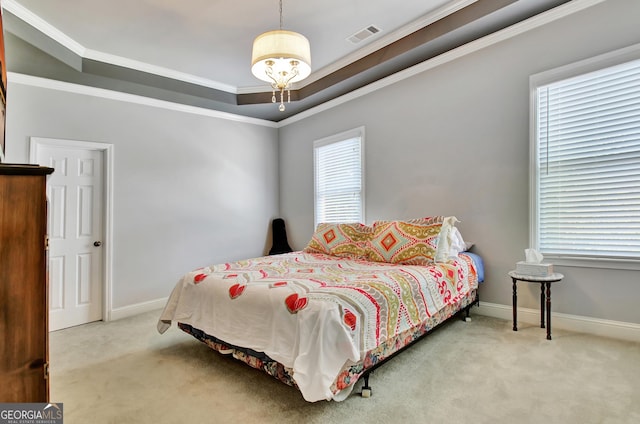 carpeted bedroom featuring a tray ceiling, crown molding, and baseboards