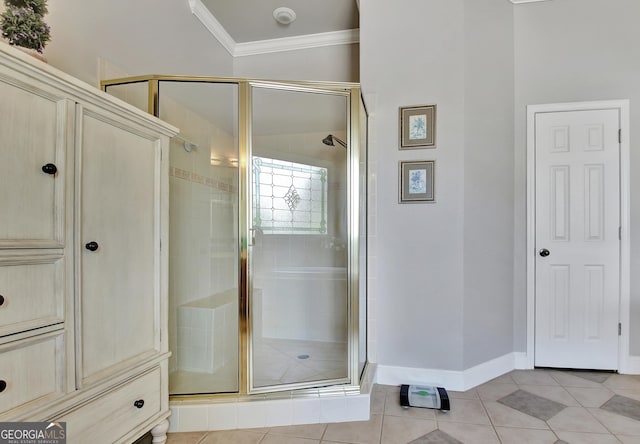 full bathroom featuring a stall shower, crown molding, tile patterned floors, and baseboards