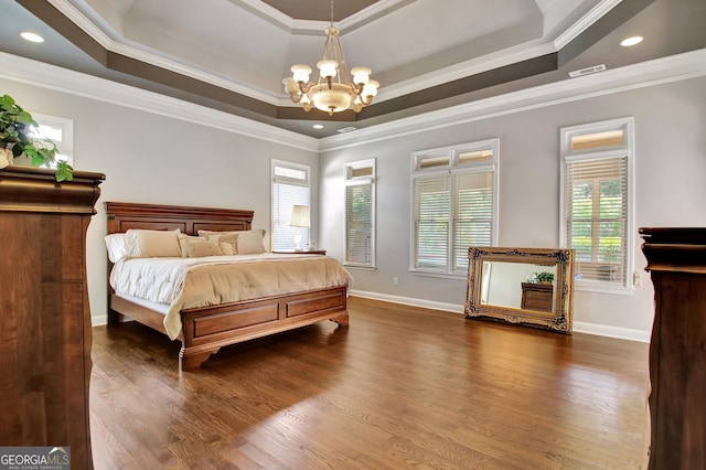 bedroom featuring a chandelier, crown molding, dark wood-style flooring, a raised ceiling, and baseboards