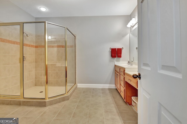 full bath featuring a shower stall, tile patterned flooring, vanity, and baseboards