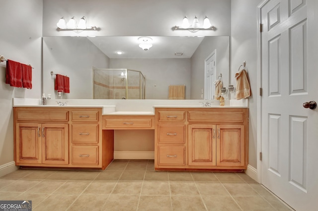 full bath with a shower stall, tile patterned flooring, double vanity, and baseboards
