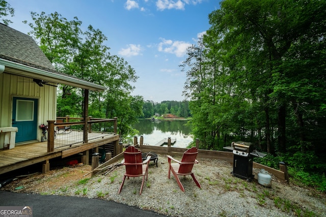 dock area with a deck with water view and an outdoor fire pit
