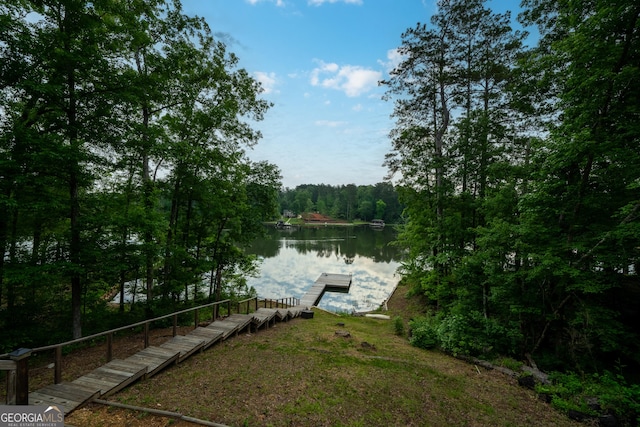 dock featuring a water view and a forest view