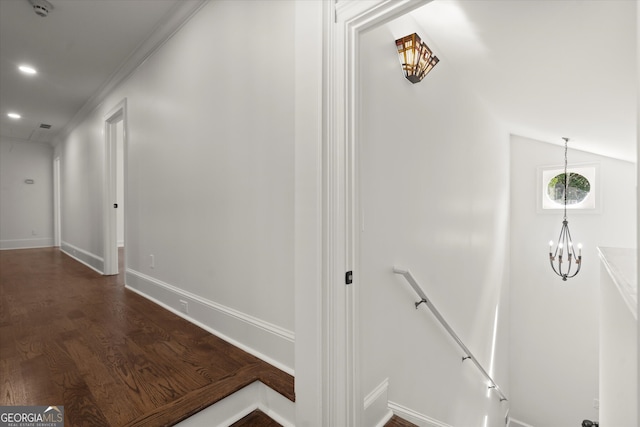 hallway featuring an upstairs landing, dark wood-style flooring, baseboards, a chandelier, and recessed lighting