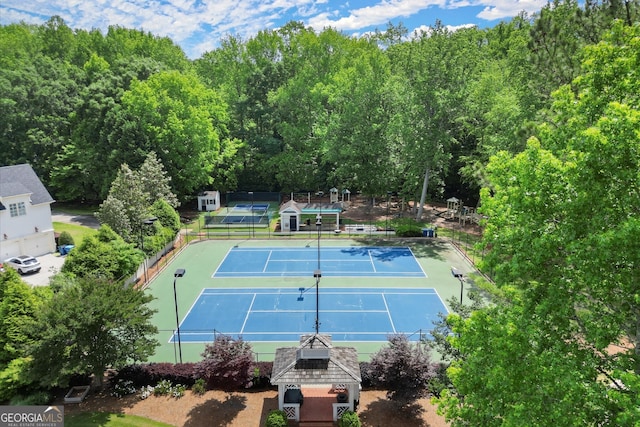 view of tennis court featuring fence