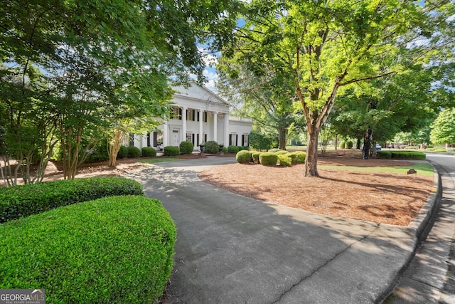 greek revival house featuring curved driveway