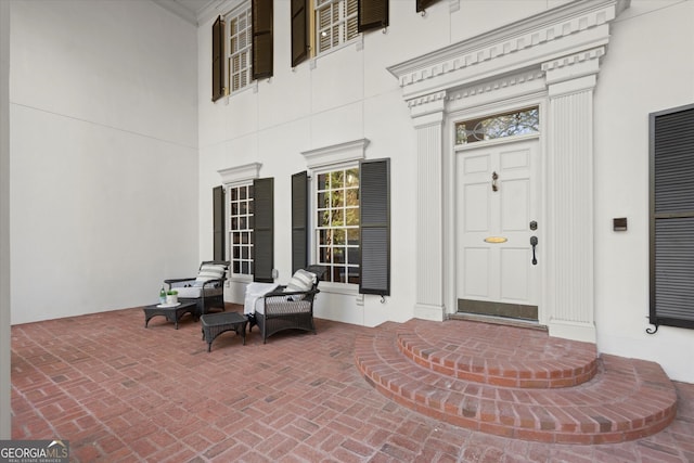 entrance to property featuring stucco siding