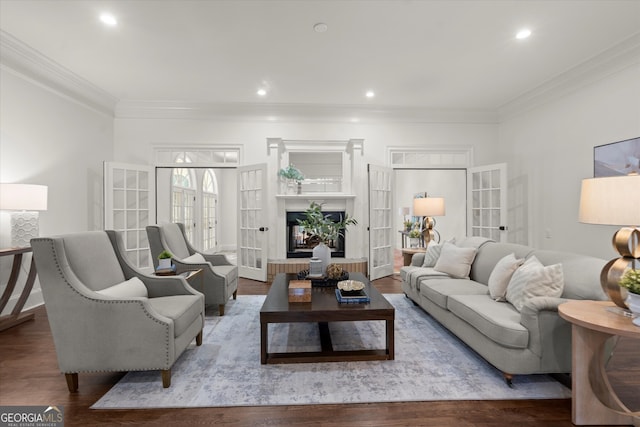 living room featuring wood finished floors, ornamental molding, and recessed lighting