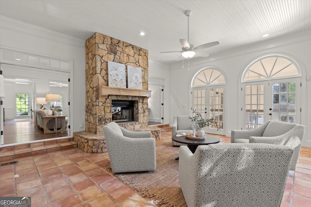 living area with a fireplace, crown molding, ceiling fan, recessed lighting, and tile patterned floors