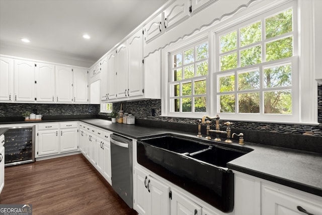 kitchen with wine cooler, dishwasher, a sink, dark countertops, and tasteful backsplash