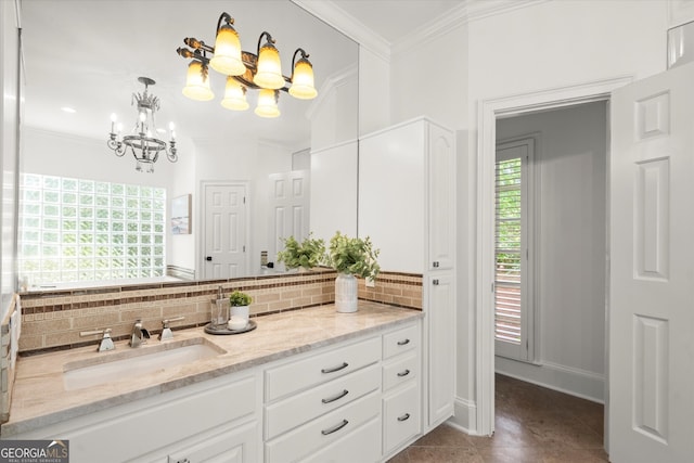 bathroom with a chandelier, tasteful backsplash, ornamental molding, vanity, and tile patterned flooring