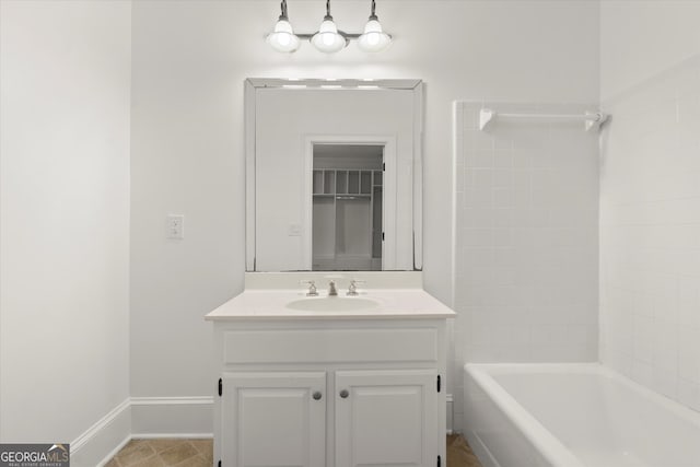 full bathroom with vanity, baseboards, and washtub / shower combination