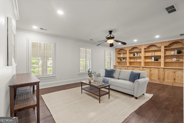 living area featuring crown molding, dark wood-style flooring, baseboards, recessed lighting, and ceiling fan