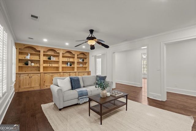 living area with ornamental molding, dark wood finished floors, ceiling fan, baseboards, and recessed lighting