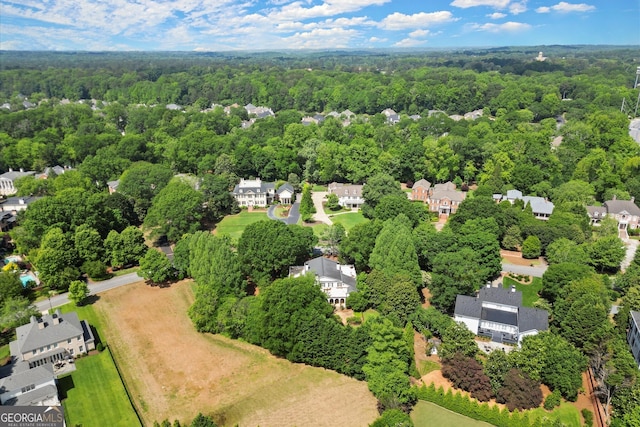 aerial view of residential area featuring a heavily wooded area