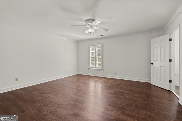 spare room featuring ceiling fan, crown molding, dark wood-style flooring, and baseboards